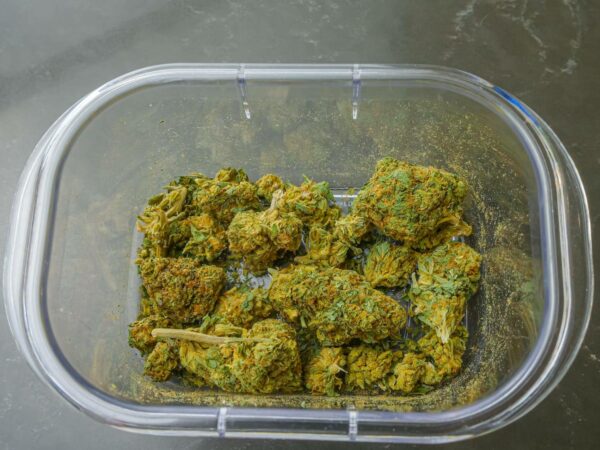 photo of cannabis flowers on glass container